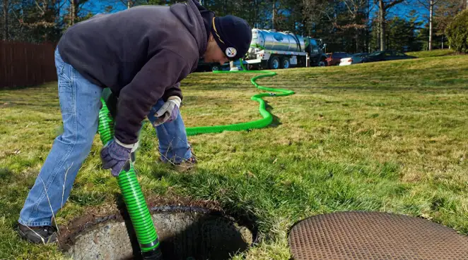 Service technician performing residential septic pumping and drainage maintenance in Cape Coral, FL